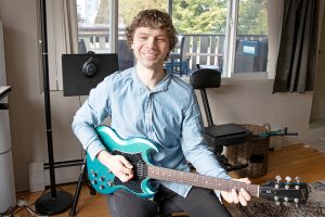 online dating profile photo - luke playing guitar at home